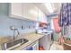 Laundry room with granite countertops and front loading washer and dryer at 7959 Palace Monaco Ave, Las Vegas, NV 89117