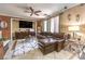 Comfortable living room featuring tile floors, a ceiling fan, plush seating, and plenty of sunlight at 7959 Palace Monaco Ave, Las Vegas, NV 89117