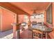 Cozy outdoor kitchen with built-in barbecue, bar, and ceiling fan at 7959 Palace Monaco Ave, Las Vegas, NV 89117