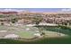 Lush golf course and community view highlighting the scenic beauty of the water, landscaping, and buildings at 8 Via Dolcetto, Henderson, NV 89011