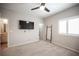 Spacious carpeted bedroom with a TV and access to the bathroom at 8 Via Dolcetto, Henderson, NV 89011