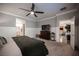 Spacious bedroom with a ceiling fan, and adjoining bathroom and sitting room at 8 Via Dolcetto, Henderson, NV 89011