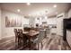 Open concept dining area featuring a dark wood table, seating for six, adjacent to the kitchen with granite countertops at 8 Via Dolcetto, Henderson, NV 89011
