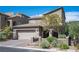 Charming home with a two-car garage, desert landscaping, and a welcoming front entrance in a residential area at 8 Via Dolcetto, Henderson, NV 89011