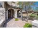 Inviting front porch with stone accents and comfortable seating, creating a warm and welcoming entry at 8 Via Dolcetto, Henderson, NV 89011