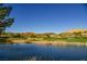 Scenic golf course view with a tranquil lake, lush green fairways, and rolling hills at 8 Via Dolcetto, Henderson, NV 89011
