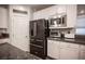 Modern kitchen featuring stainless steel appliances, white cabinets, granite countertops, and a stylish subway tile backsplash at 8 Via Dolcetto, Henderson, NV 89011