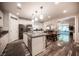 Open-concept kitchen featuring granite countertops, modern appliances, and seamless flow to dining area at 8 Via Dolcetto, Henderson, NV 89011