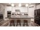 A kitchen featuring white cabinets, stainless steel appliances, granite countertops, and modern pendant lighting at 8 Via Dolcetto, Henderson, NV 89011