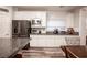Kitchen featuring white cabinets, granite countertops, stainless steel appliances, and a stylish subway tile backsplash at 8 Via Dolcetto, Henderson, NV 89011