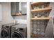 Laundry room with modern appliances and decorative shelves at 8 Via Dolcetto, Henderson, NV 89011