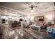 A living room featuring an open concept design to the kitchen, wood floors, comfortable seating, and neutral color palette at 8 Via Dolcetto, Henderson, NV 89011