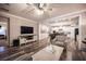 Bright living room flows into the kitchen, featuring hardwood floors and neutral décor at 8 Via Dolcetto, Henderson, NV 89011