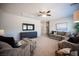 Spacious living room featuring comfortable seating, a ceiling fan, and a large entertainment center at 8 Via Dolcetto, Henderson, NV 89011