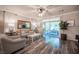 Inviting living room with wood floors, comfortable seating, a ceiling fan, and sliding glass doors to the outdoor patio at 8 Via Dolcetto, Henderson, NV 89011