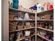 Organized walk-in pantry with ample shelving filled with various food items and storage containers at 8 Via Dolcetto, Henderson, NV 89011