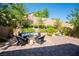 Inviting outdoor patio featuring a cozy fire pit, comfortable seating, and lush landscaping at 8 Via Dolcetto, Henderson, NV 89011
