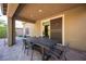 Outdoor patio area with a dining table, chairs, and a sliding glass door to the house at 8 Via Dolcetto, Henderson, NV 89011