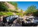 Relaxing outdoor patio area with comfortable seating around a fire pit and serene landscaping at 8 Via Dolcetto, Henderson, NV 89011