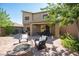 Charming outdoor patio with a fire pit, seating, outdoor kitchen, and a covered dining area at 8 Via Dolcetto, Henderson, NV 89011