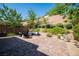 Spacious patio with a fire pit, comfortable seating, and beautiful landscaping for outdoor enjoyment at 8 Via Dolcetto, Henderson, NV 89011