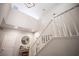 A bright foyer featuring a staircase with white railing, high ceilings, and modern decor at 8 Via Dolcetto, Henderson, NV 89011