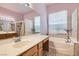 Bathroom with a soaking tub, walk-in shower, and vanity with sink at 8777 Shady Peak Way, Las Vegas, NV 89123