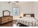 Cozy bedroom with a comfortable bed, a dresser with mirror and natural light streaming through the sheer curtains at 8777 Shady Peak Way, Las Vegas, NV 89123