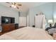 Bedroom with wood floors, a large bed, dresser, closet, and a comfortable atmosphere at 8777 Shady Peak Way, Las Vegas, NV 89123