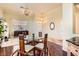Charming dining area with hardwood floors, a glass table set, and a view into the living room at 8777 Shady Peak Way, Las Vegas, NV 89123