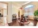 Elegant dining room with hardwood floors, a glass table set, and a bright, open feel at 8777 Shady Peak Way, Las Vegas, NV 89123