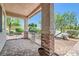 Cozy front porch with brick columns and tile flooring, offering a charming outdoor space at 8777 Shady Peak Way, Las Vegas, NV 89123