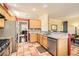 Well-lit kitchen features tile floors, light wood cabinets, stainless steel appliances, and granite countertops at 8777 Shady Peak Way, Las Vegas, NV 89123