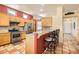 Kitchen with stainless steel appliances, light wood cabinets, granite countertops, and tile flooring at 8777 Shady Peak Way, Las Vegas, NV 89123