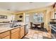 Spacious kitchen with tile floors, granite countertops, stainless steel appliances, and a breakfast nook at 8777 Shady Peak Way, Las Vegas, NV 89123