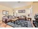 Living room with neutral walls, tile floors, plush couches, coffee table, and area rug at 8777 Shady Peak Way, Las Vegas, NV 89123