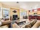 Living room with cozy seating area, tile floors, and access to the eat-in kitchen at 8777 Shady Peak Way, Las Vegas, NV 89123