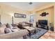 Inviting living room with tile floors, plush sofas, coffee table, and an area rug at 8777 Shady Peak Way, Las Vegas, NV 89123
