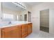 Bright bathroom boasts double sinks, large mirror, and walk-in closet access at 908 Cypress Gold Ct, North Las Vegas, NV 89031