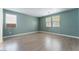 Spacious bedroom with natural light, complemented by sleek, wood-look floors and neutral paint at 908 Cypress Gold Ct, North Las Vegas, NV 89031