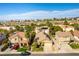 Aerial view of a well-maintained home featuring solar panels, landscaping, and a vibrant neighborhood at 922 Lloyd George Dr, Henderson, NV 89052
