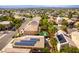 High-angle view showcasing a home with solar panels, backyard pool, and lush surrounding trees at 922 Lloyd George Dr, Henderson, NV 89052