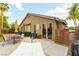 Relaxing backyard with patio, hammock, dining set, barbecue grill, and mature landscaping at 922 Lloyd George Dr, Henderson, NV 89052