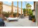 Private backyard oasis with hammock, patio furniture, lush landscaping and tall palm trees at 922 Lloyd George Dr, Henderson, NV 89052