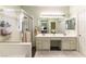 Bathroom with a double sink vanity, large mirror with Hollywood lights, and glass enclosed shower at 922 Lloyd George Dr, Henderson, NV 89052