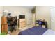 Bedroom featuring a computer desk, storage and shelving, and blue and white bedding at 922 Lloyd George Dr, Henderson, NV 89052