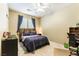 Simple bedroom with a small bed, desk, and ceiling fan, perfect for a or teenager at 922 Lloyd George Dr, Henderson, NV 89052