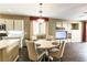 Inviting dining area with modern lighting and views into the living room and kitchen at 922 Lloyd George Dr, Henderson, NV 89052