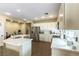 Well-lit kitchen with stainless steel appliances, quartz countertops, and ample storage space at 922 Lloyd George Dr, Henderson, NV 89052