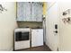 Efficient laundry room equipped with a washer, dryer, and storage space above at 922 Lloyd George Dr, Henderson, NV 89052